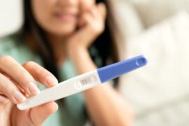 lady showing pregnancy test